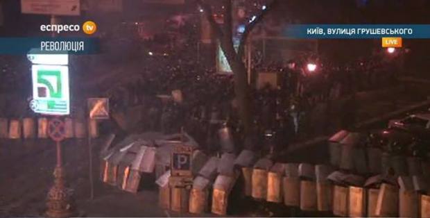 Soldiers stepping away from burning buses and shielding themselves