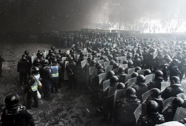 Berkut special riot forces and interior ministry forces amassing on Hrushevsky St. in Kiev facing a wall of tyre smoke put up by protesters to keep them at bay. January 23, 2014.