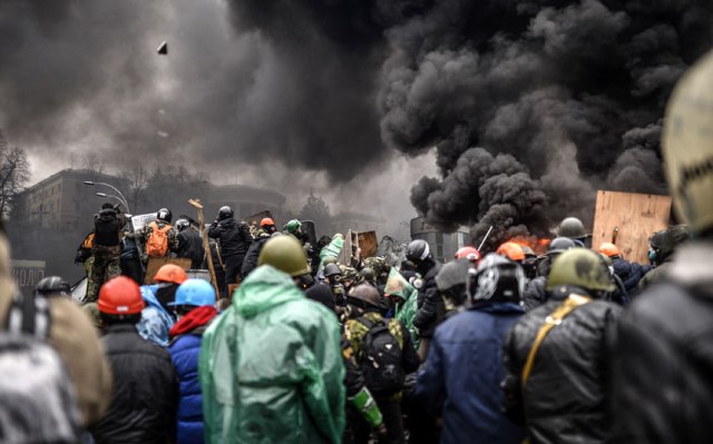 Protesters gather behind barricades during clashes with police. Bulent Kilic-AFP-Getty Images