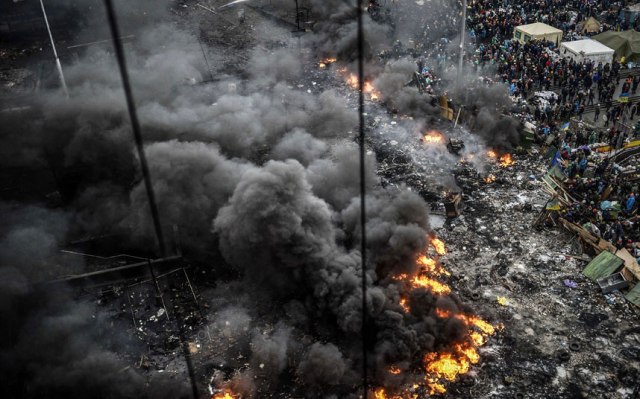 Protesters stand behind burning barricades during a face-off against police. Bulent Kilic:AFP:Getty Images