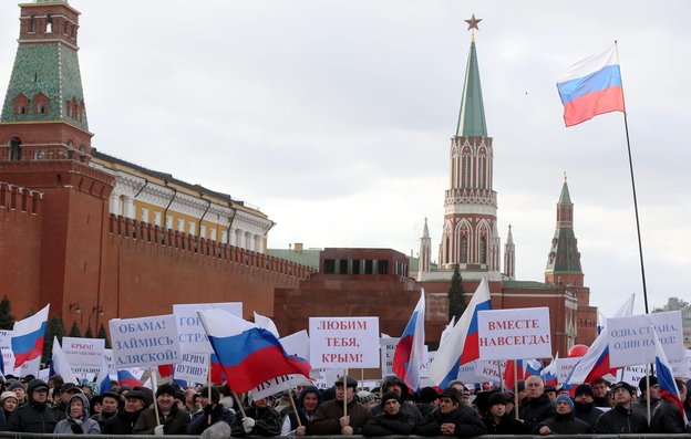 Russians in Moscow's Red Square hold banners reading, "Love You Crimea!" "Together For All Time" and "Obama, Think About Alaska!" during a March 18 rally celebrating the annexation of Crimea. Photo: Sergei Ilnitsky/EPA/Landov