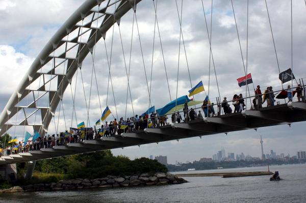 Parade at Toronto, Canada's lakeside waterfront with CN Tower in the background 