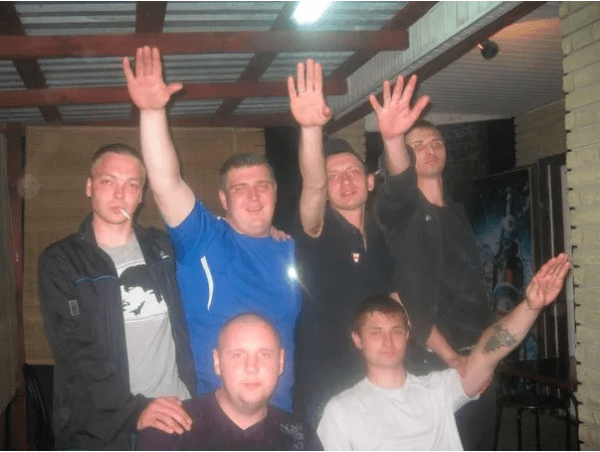 Alexander "de Krog" Matyushin and friends, performing a Nazi salute. The political affiliations of the "DNR" founder (top row, second right) are clear without further comment.