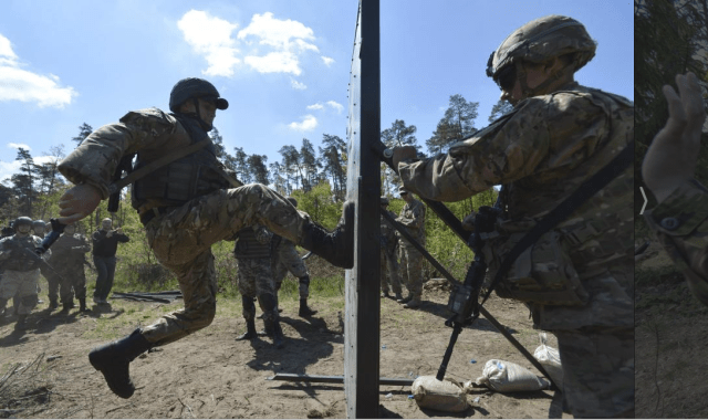 A serviceman of the U.S. Army's 173rd Airborne Brigade Combat Team (R) trains Ukrainian soldiers during a joint military exercise called 'Fearless Guardian 2015' at the military training area in Yavoriv, outside Lviv, Ukraine, May 12, 2015. REUTERS/OLEKSANDR KLYMENKO. Source.