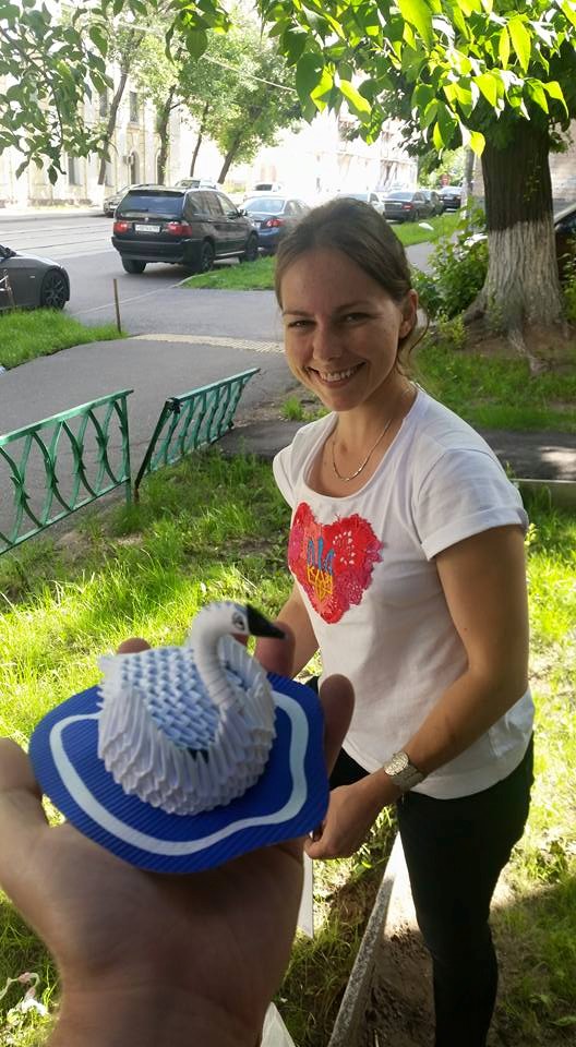 Vira Savchenko looking at the dolls made by her sister. Photo: Ilya Novikov. Source