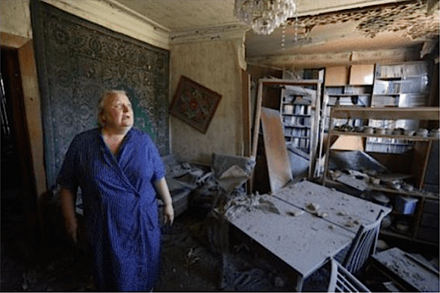 In Donetsk, a woman assesses the damages to her house from shelling on July 19, 2015. Photo: Aleksey Filippov, AFP. Source: https://twitter.com/molodyko/status/623146475032313856