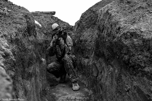 A sniper takes aim in Shyrokyne. Photo: Noah Brooks.  