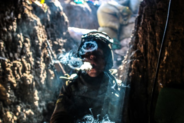 A soldier takes a smoke break after a firefight in Shyrokyne. Photo: Noah Brooks