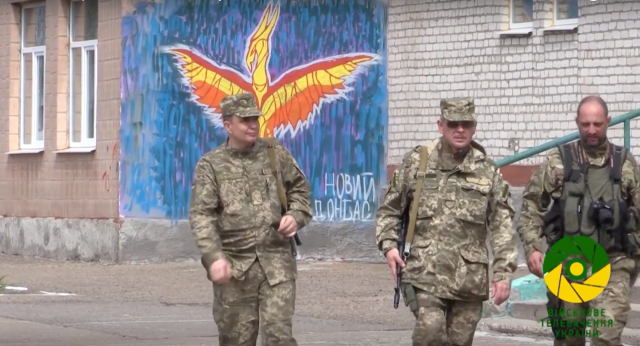 Ukrainian Armed Forces at Stanytsia Luhanska in front of "New Donbas" Phoenix rising graffiti.