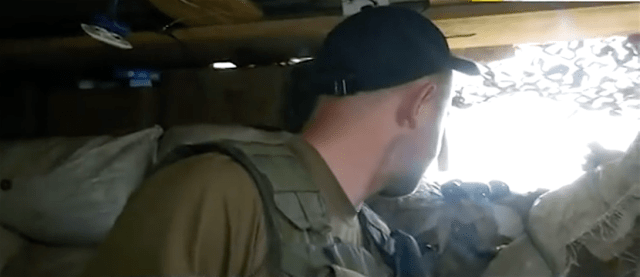 June: Avdiivka. Watching for terrorists from the hole with "Boy" [call sign] a soldier of the Special Purpose Regiment "Kyiv," a new unit of the Armed Forces of Ukraine. 